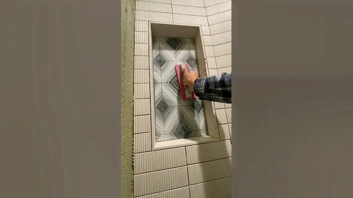 Glass mosaic tile installation in back of soap niche